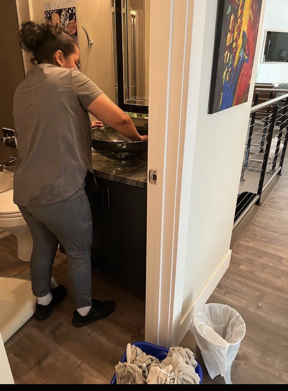 Linda’s Housekeeping cleaning a bathroom sink and vanity